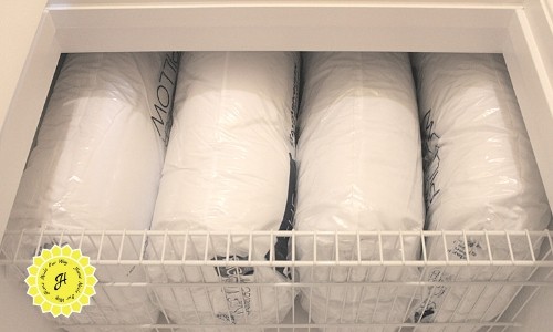 stacked pillows in linen closet
