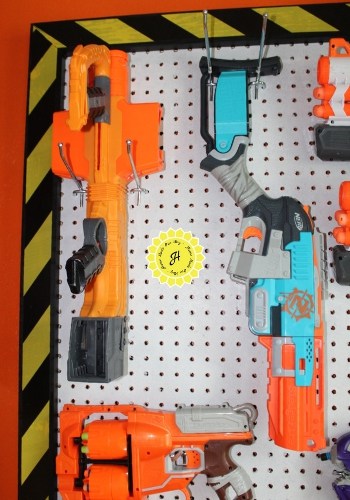 image of tall nerf guns on pegboard placed vertically