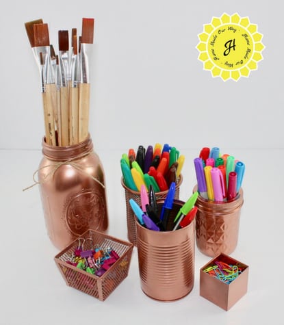 repurposed containers sprayed in copper paint for desk supplies
