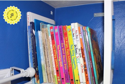 books placed in top tier of bookshelf tower