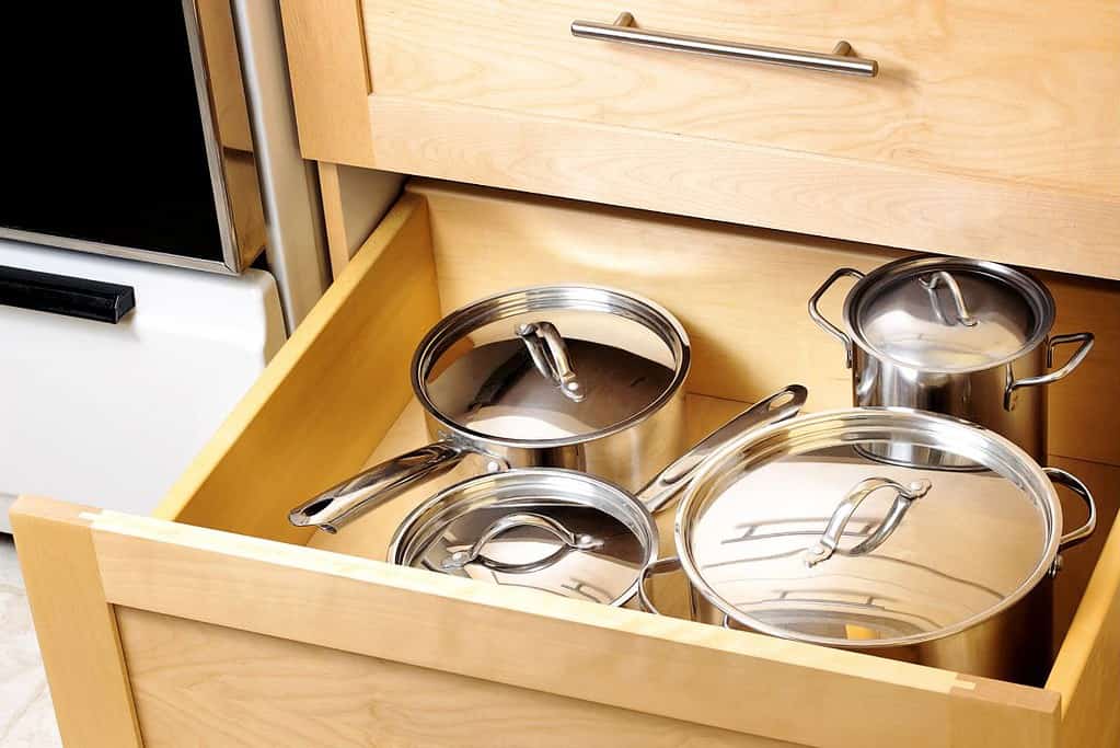 pots with lids in kitchen drawer